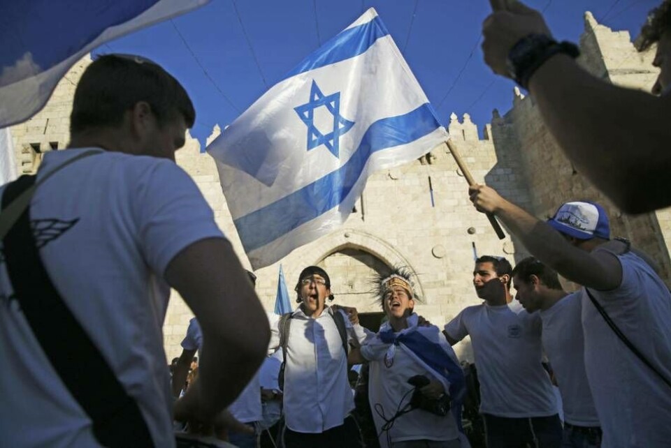 Israeli youth waves national flag outside the Old City's Damascus Gate in Jerusalem Wednesday, May 24, 2017, during Jerusalem Day which marks the 50th anniversary of Israel's capture of the city's eastern half from Jordanian control during the Six-Day War in 1967. Israeli youth waves national flag outside the Old City's Damascus Gate in Jerusalem Wednesday, May 24, 2017, during Jerusalem Day which marks the 50th anniversary of Israel's capture of the city's eastern half from Jordanian control during the Six-Day War in 1967.