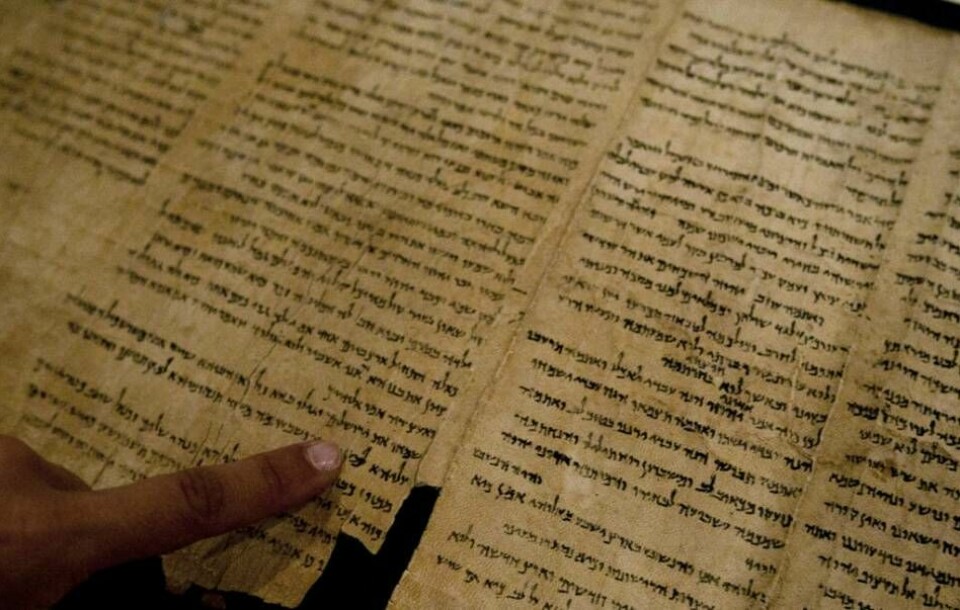 Delar av Dödahavsrullarna är i väsentligt bättre skick än fragmenten. Här pekar en israelisk museianställd på ordet ”Jerusalem” i en av texterna, som bland annat innehåller de tidigaste utgåvorna av den hebreiska bibeln som har hittats. Foto: Sebastian Scheiner/AP/TT