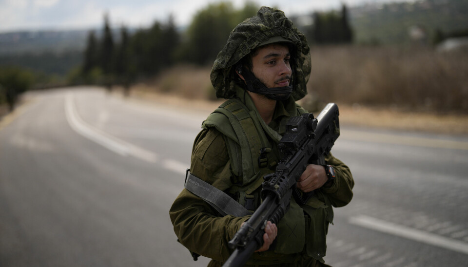 An Israeli soldier patrols a road with others near the border between Israel and Lebanon, Monday, Oct. 16, 2023. (AP Photo/Francisco Seco) FS105