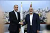 In this picture released by the Iranian Foreign Ministry on Wednesday, Dec. 20, 2023, Iran's Irans foreign Minister Hossein Amirabdollahian, left, shakes hands with Hamas chief Ismail Haniyeh, right, during their meeting in Doha, Qatar. (Iranian Foreign Ministry via AP) VAH101