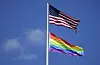 The flag of the United States of America, top, and a Rainbow Color Flag, bottom, wave on top of the US embassy in Berlin, Germany, Saturday, July 10, 2021. (AP Photo/Michael Sohn) SOB107