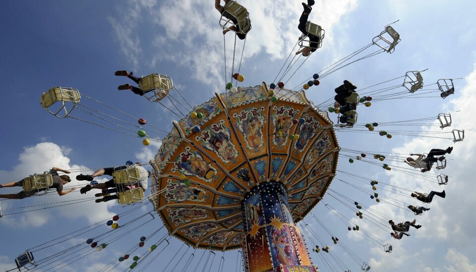 People ride on a merry-go-round at the opening of the Cranger Fair in Herne, western Germany, Friday, Aug. 6, 2010. What once started as a horse market in the 15th century has become one of Germany's biggest fairs with expected four million visitors within ten days. (AP Photo/Martin Meissner)