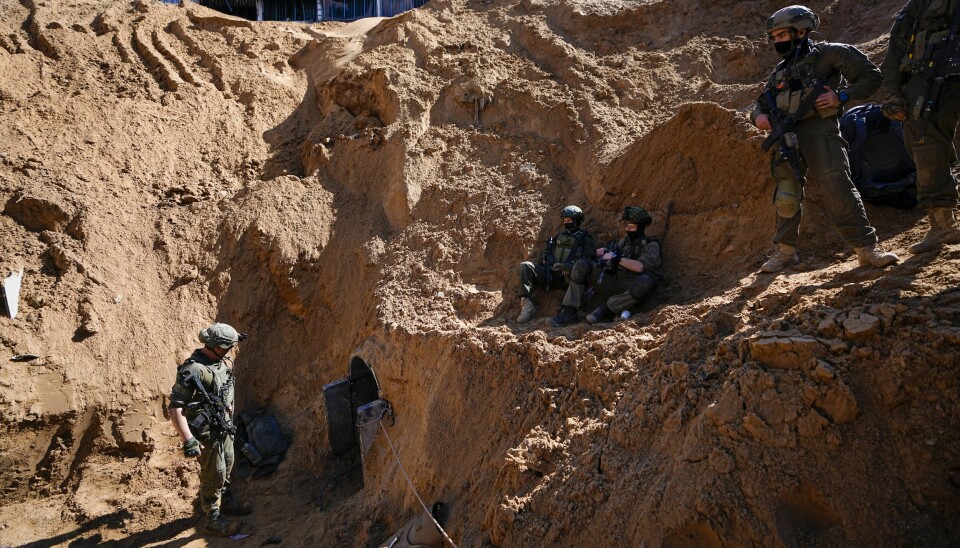 Israeli soldiers guard a crater-like hole giving way to a small tunnel entrance in the UNRWA compound where the military discovered tunnels underneath the main headquarters of the U.N. agency that the military says Hamas militants used to attack its forces during a ground operation in Gaza, Thursday, Feb. 8, 2024. The Israeli military says it has discovered tunnels underneath the main headquarters of the U.N. agency for Palestinian refugees in Gaza City, alleging that Hamas militants used the space as an electrical supply room. The unveiling of the tunnels marked the latest chapter in Israel's campaign against the embattled agency, which it accuses of collaborating with Hamas. (AP Photo/Ariel Schalit) XOB119