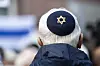 A participant in a pro-Israel rally wears a kippah with a Star of David in front of St. Paul's Church in Frankfurt, Germany, Saturday, Oct. 14, 2023. (Hannes P. Albert/dpa via AP) DSOB113 MANDATORY CREDIT