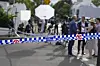 Media wait outside a police cordon at a street where houses were vandalized with anti-Israel slogans in the Sydney suburb of Woollahra, Australia, Wednesday, Dec. 11, 2024. (AP Photo/Mark Baker) XMB104