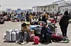 Afghan refugees who returned after fleeing Iran to escape deportation and conflict gather at a UNHCR facility near the Islam Qala crossing in western Herat province, Afghanistan, on Friday, June 20, 2025. (AP Photo/Omid Haqjoo) XEM136