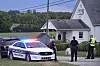 Police stand at the front of the Richmond Road Baptist Church as other officers maintain a perimeter following a shooting at the church in Lexington, Ky., Sunday, July 13, 2025. (AP Photo/Timothy D. Easley) KYTE102