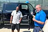 Richard Pryor, left, and Matthew Demmer stand in front of the new 2025 Ford F-150 pickup Demmer Ford gifted Pryor Thursday, July 10, 2025, in Wayne, Mich. (AP Photo/Corey Williams) RPCW402