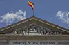 The Spanish flag flutters atop of the Spanish parliament in Madrid, Spain, Friday, May 24, 2019. The lower chamber of Spain's Parliament has suspended four Catalan separatist politicians from their recently gained positions as national lawmakers because they are currently in jail during an ongoing trial for rebellion and other charges.(AP Photo/Bernat Armangue)