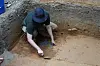 A worker digs in an archeological site in Kisatchie National Forest, La., Wednesday, June 7, 2023. This summer, archaeologists have been gingerly digging up the ground at the site in Vernon Parish to unearth and preserve the evidence of prehistoric occupation. The site was found by surveyors in 2003, according to the U.S. Forest Service. Hurricanes Laura and Delta uprooted trees and exposed some of the artifacts. Further damage has been done by looters making unauthorized digs. Forest officials say the site shows evidence of generations of people living in the area going back 12,000 years. (AP Photo/Gerald Herbert) LAGH207