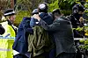 Members of the Jewish community comfort each other near to the Heaton Park Hebrew Congregation synagogue, in Crumpsall, Manchester, England, Thursday, Oct. 2, 2025 after Police reported that two people were killed and three others were seriously injured in a synagogue attack in northern England. (Peter Byrne/PA via AP) LFP202