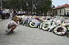 A young woman kneels down by a floral tribute by the Bondi Pavilion at Bondi Beach on Tuesday, Dec. 16, 2025, following Sunday's shooting in Sydney, Australia. (AP Photo/Mark Baker) XMB210