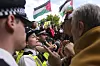 Protesters argue with police officers during a protest to support Palestine Action in London, Saturday, Sept. 6, 2025.(AP Photo/Joanna Chan) FAS115