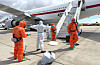 A Spanish passenger is sprayed with disinfectant by Spanish government officials before boarding a plane after disembarking from the hantavirus-stricken cruise ship MV Hondius at Tenerife airport in the Canary Islands, Spain, Sunday, May 10, 2026. (AP Photo) EM156