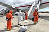 A Spanish passenger is sprayed with disinfectant by Spanish government officials before boarding a plane after disembarking from the hantavirus-stricken cruise ship MV Hondius at Tenerife airport in the Canary Islands, Spain, Sunday, May 10, 2026. (AP Photo) EM156