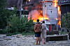 People watch as building burns after a Russian missile attack in Kyiv, Ukraine, Sunday, May 24, 2026. (AP Photo/Efrem Lukatsky) XSG105
