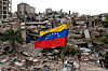 Residents and rescue workers search through the rubble of buildings damaged in the earthquakes that struck La Guaira, Venezuela, Thursday, July 2, 2026. (AP Photo/Ariana Cubillos) XRM141