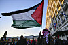 A pro-Palestinian protester holds a Palestinian flag during a rally in Athens, Friday, Nov. 17, 2023. Thousands of people are marching through central Athens to mark the 50th anniversary of a pro-democracy student uprising that was violently put down by the military dictatorship ruling Greece in 1973. (AP Photo/Michael Varaklas) XPG104