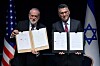 Israeli Foreign Minister Gideon Sa'ar (right) and U.S. Ambassador to Israel Mike Huckabee present the land‑allocation agreement for the permanent U.S. Embassy in Jerusalem to the audience during a ceremony on Wednesday, July 1, 2026. (AP Photo/Ohad Zwigenberg) OZW105