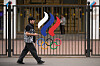 A man walks past a fence with Olympic Rings in front of the Russian National Olympic Committee building in Moscow, on Tuesday, July 7, 2026. (AP Photo/Pavel Bednyakov) XAZ104