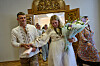 Newly-married couple Liudmyla Ryzhak, right, and her husband Leonid Ryzhak leave after getting married, following a Russian missile and drone attack in Kyiv, Ukraine, Tuesday, Sept. 8, 2026. (AP Photo/Francisco Seco) XFS105