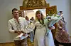 Newly-married couple Liudmyla Ryzhak, right, and her husband Leonid Ryzhak leave after getting married, following a Russian missile and drone attack in Kyiv, Ukraine, Tuesday, Sept. 8, 2026. (AP Photo/Francisco Seco) XFS105